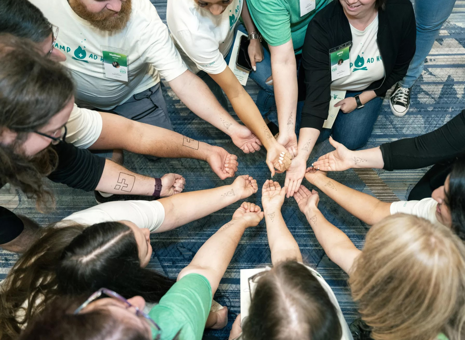 A group of Ad Hoc LLC employees showing off their temporary tattoos